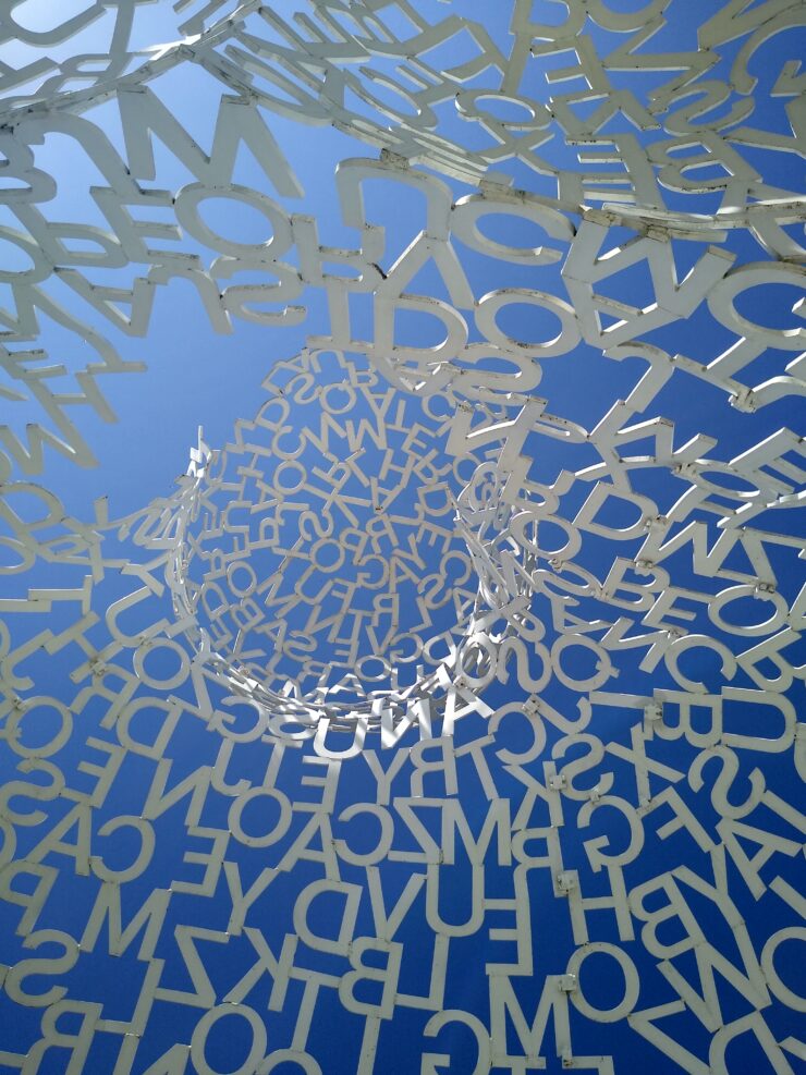 A statue made of lots of floating letters, featured at the Pappajohn's Sculpture Park sponsored by the Des Moines Art Center.