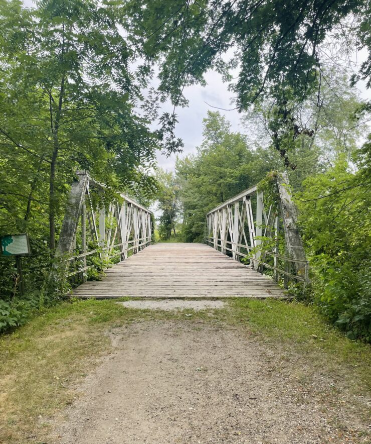 A wide, rustic bridge in Chichaqua Bottoms Greenbelt